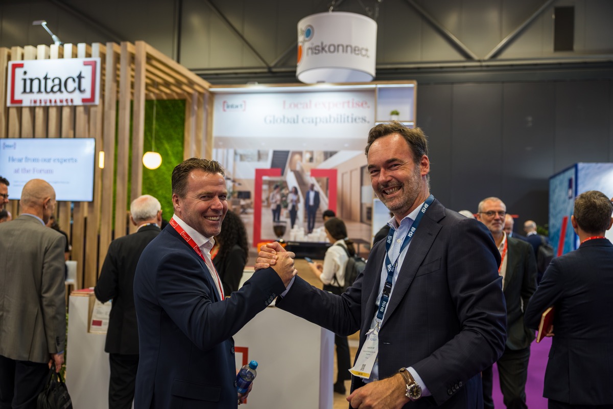 Business handshake at Intact Insurance booth captured by trade show photographer