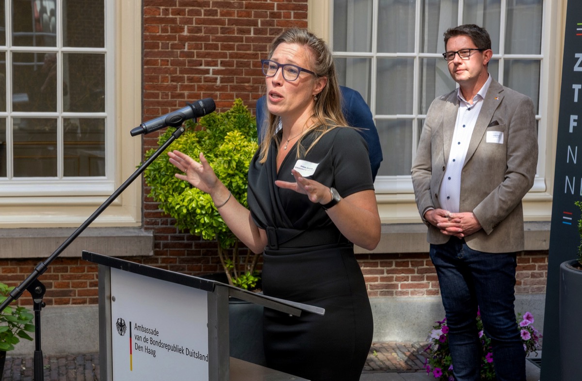 Attendees in conversation during a corporate event at an embassy in The Hague — event photographer