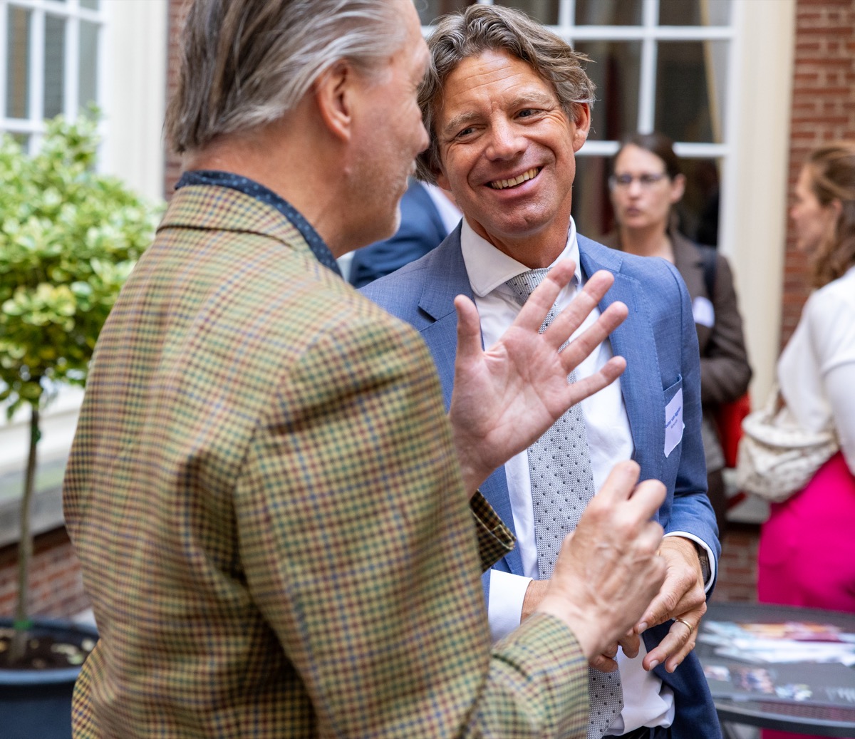 Guests in conversation during a diplomatic reception at an embassy in The Hague