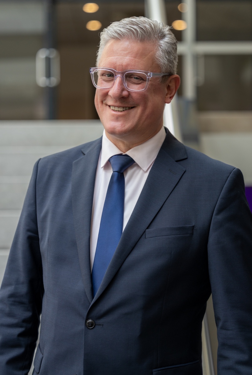 Corporate portrait of an executive with glasses at World Forum